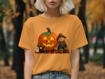 Orange t-shirt with a Halloween graphic of a jack-o'-lantern, scarecrow, and spooky figures.