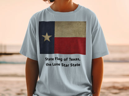 Texas flag graphic on light blue t-shirt with "State Flag of Texas, the Lone Star State" text.