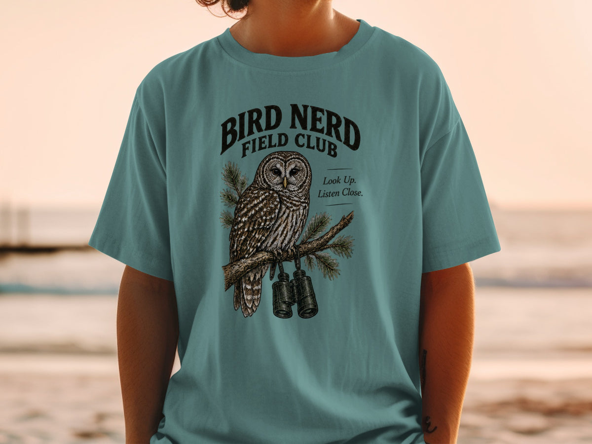 Teal t-shirt with "Bird Nerd Field Club" text, an owl, and binoculars.