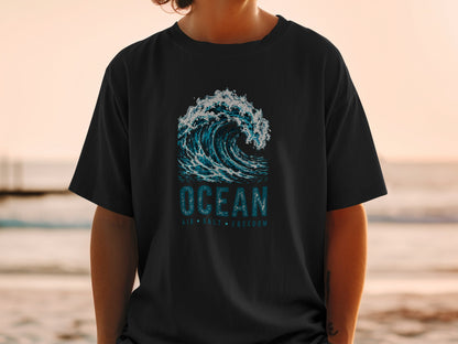 Black t-shirt with a crashing wave graphic and text "OCEAN AIR SALT FREEDOM".