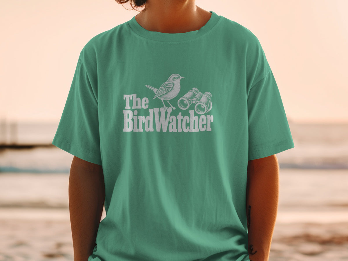 Green t-shirt with "The BirdWatcher" text, bird, and binoculars graphic.