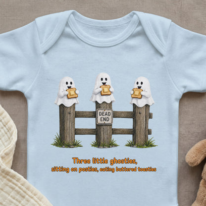 Light blue baby bodysuit with illustration of ghosts eating toast on fence posts.