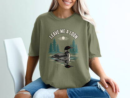 Green t-shirt with "LEAVE ME A LOON" text and loon graphic over water.