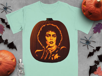 A light teal t-shirt featuring a carved pumpkin graphic of Frank-N-Furter surrounded by Halloween decorations.
