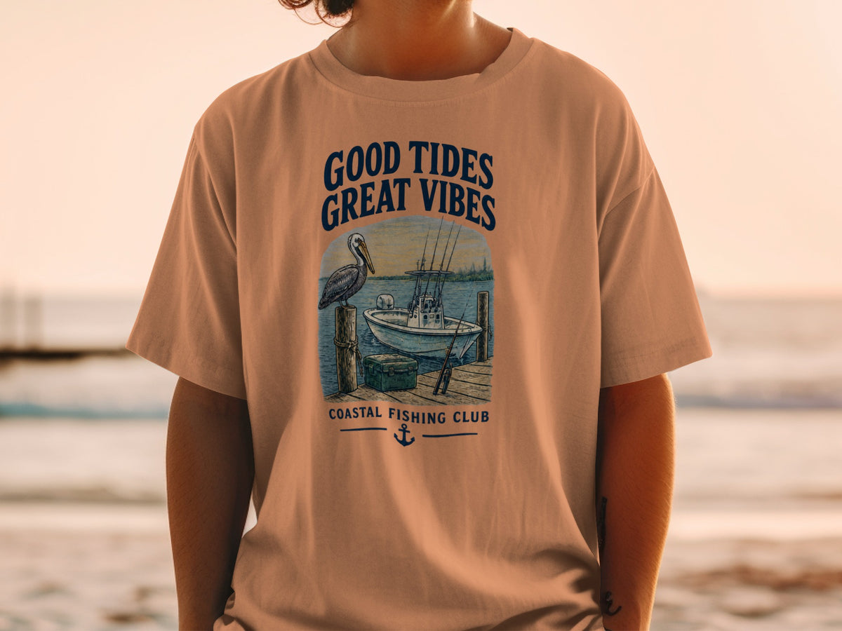 T-shirt with "Good Tides Great Vibes" text and fishing scene with boat and pelican.