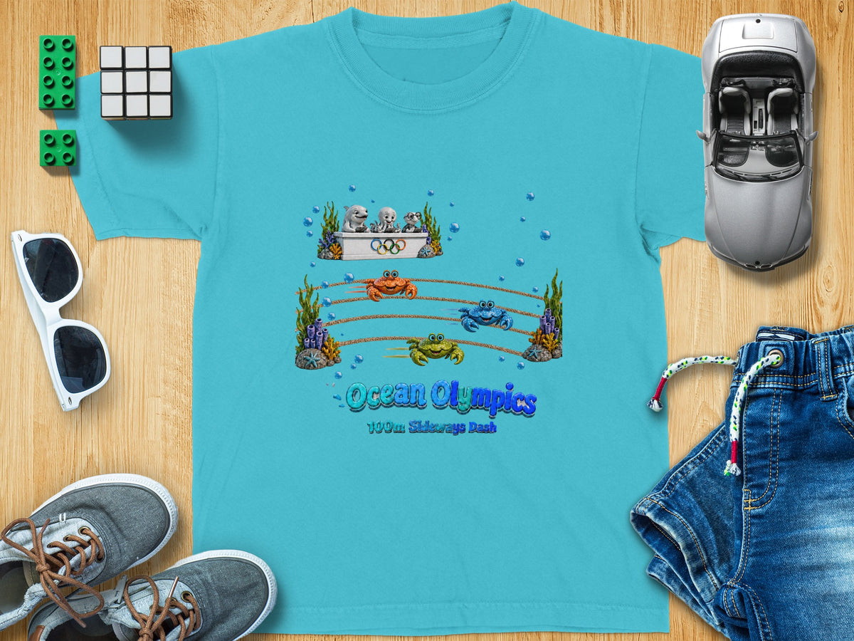 Children's turquoise t-shirt with "Ocean Olympics" and crab race graphic.