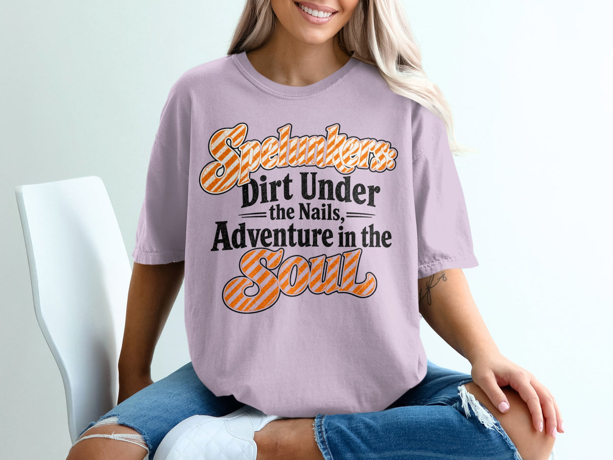 Lavender t-shirt with text "Spelunkers Dirt Under the Nails Adventure in the Soul".