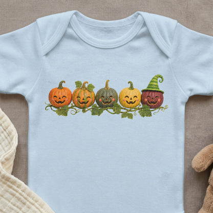 Light blue baby onesie with line of five smiling jack-o'-lanterns and green striped hat.