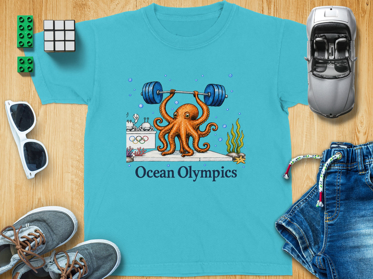 Teal t-shirt with an octopus lifting a barbell, text "Ocean Olympics" below.