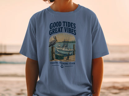 Blue t-shirt graphic with text "Good Tides Great Vibes" and fishing scene.