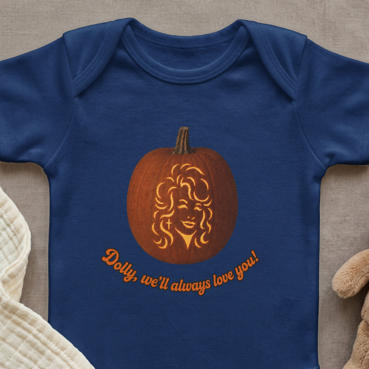 Navy blue bodysuit with a pumpkin carved with Dolly Parton's face and text.