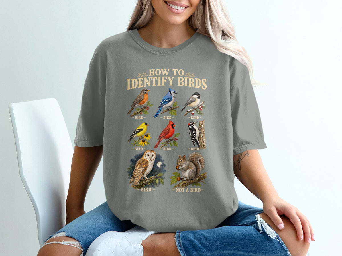 T-shirt graphic with text "How To Identify Birds" and illustrations of birds and a squirrel.