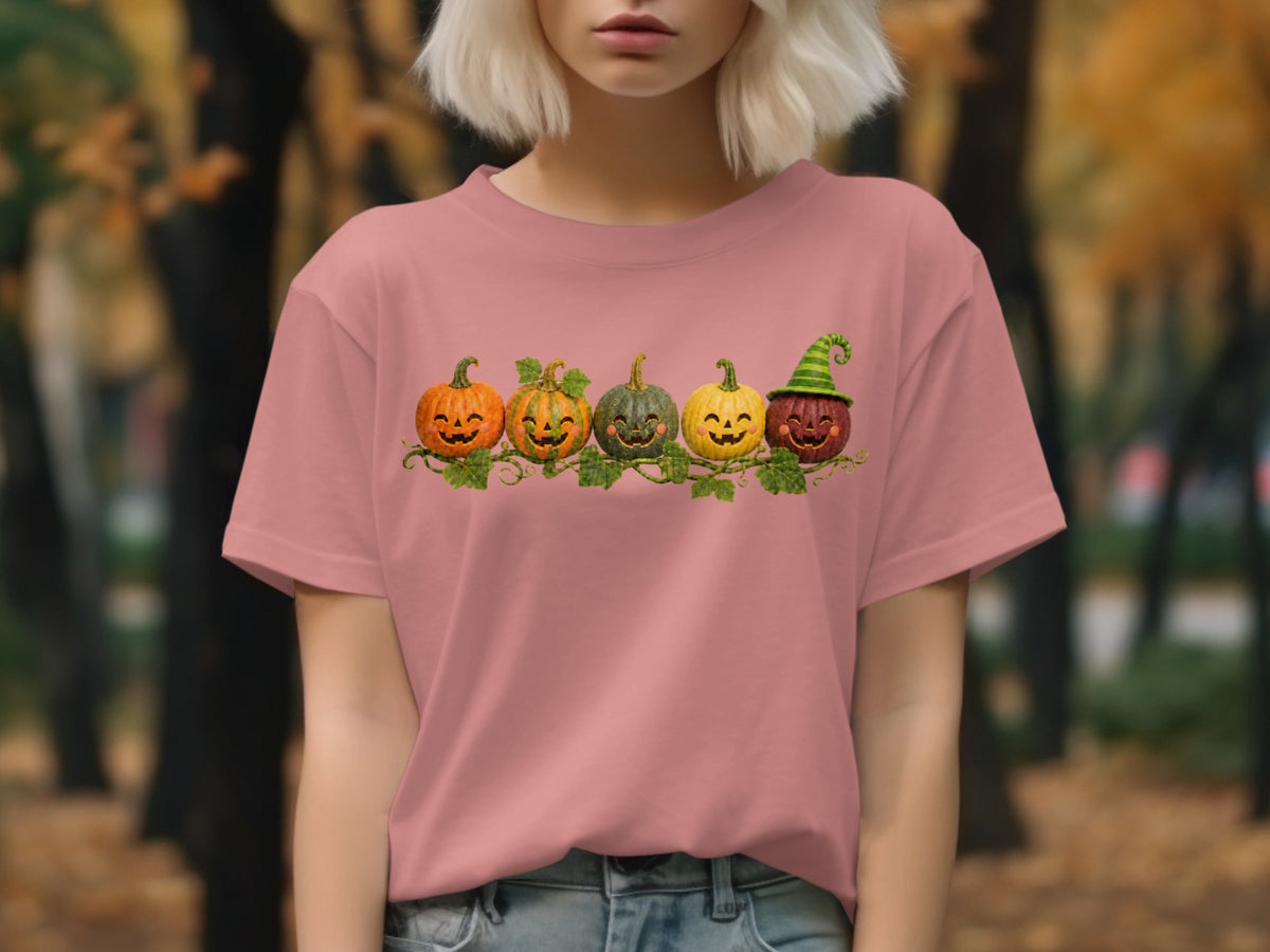 Five smiling jack-o'-lanterns and pumpkins with a green witch hat on a vine.
