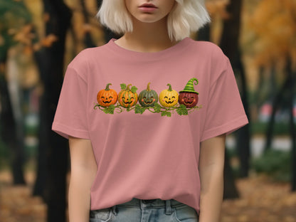 Five smiling jack-o'-lanterns and pumpkins with a green witch hat on a vine.