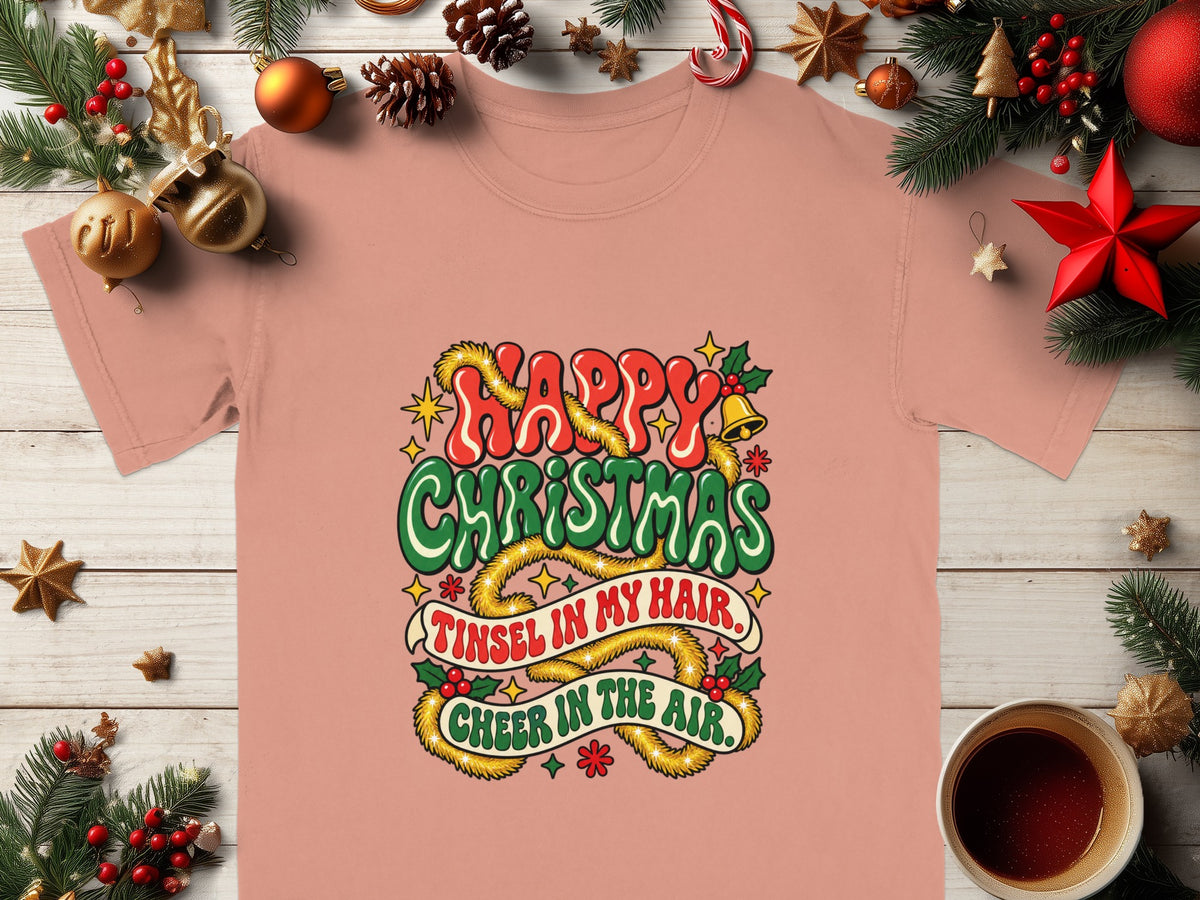 Pink t-shirt with "Happy Christmas Tinsel in My Hair Cheer in the Air" graphic.