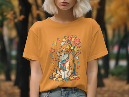 Orange t-shirt with an illustration of a ginger cat wearing a scarf sitting under an autumn tree.