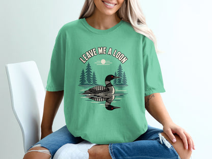 Green t-shirt with a loon graphic and text "Leave Me a Loon."