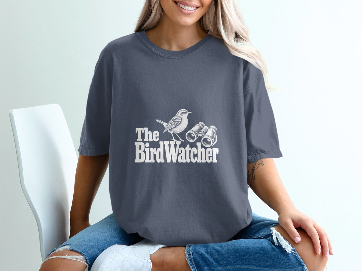 Dark gray t-shirt with "The Bird Watcher" text and bird graphic.