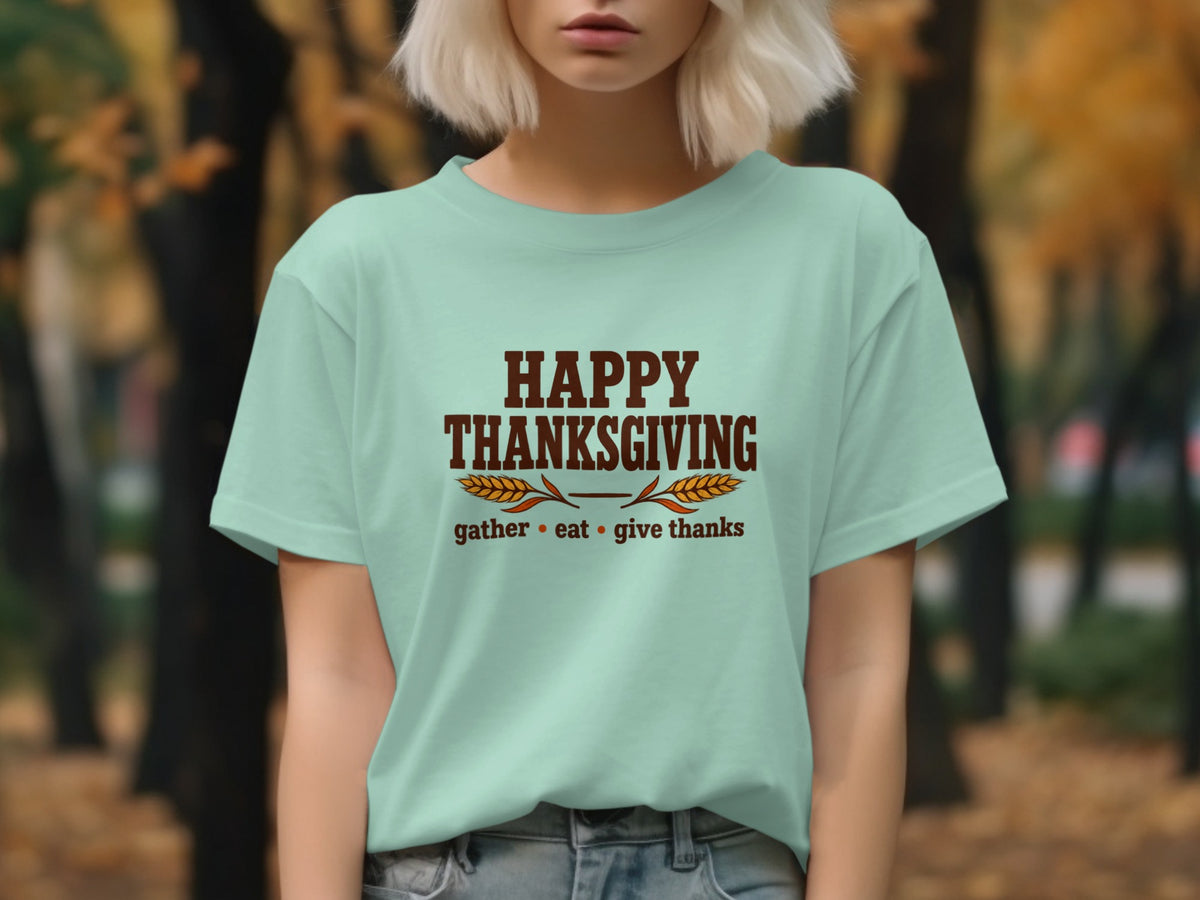 Light blue t-shirt with "Happy Thanksgiving gather eat give thanks" text.