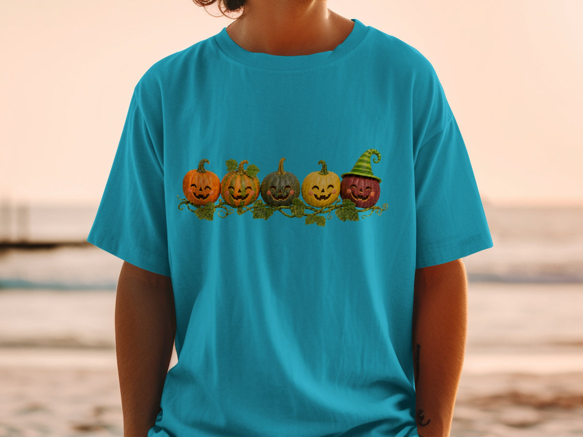 Five carved pumpkins with happy faces, one wearing a striped hat, on a vine.