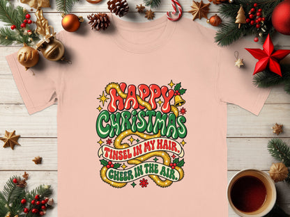 Pink t-shirt with "Happy Christmas, Tinsel in My Hair, Cheer in the Air" text.