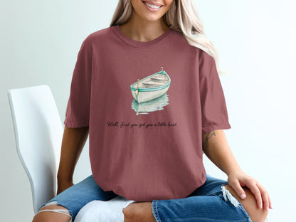 Watercolor boat graphic on maroon t-shirt with text "Well, first you get you a little boat".
