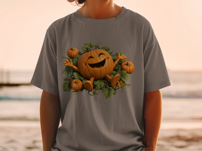 T-shirt with a smiling pumpkin character surrounded by smaller pumpkins and green leaves.