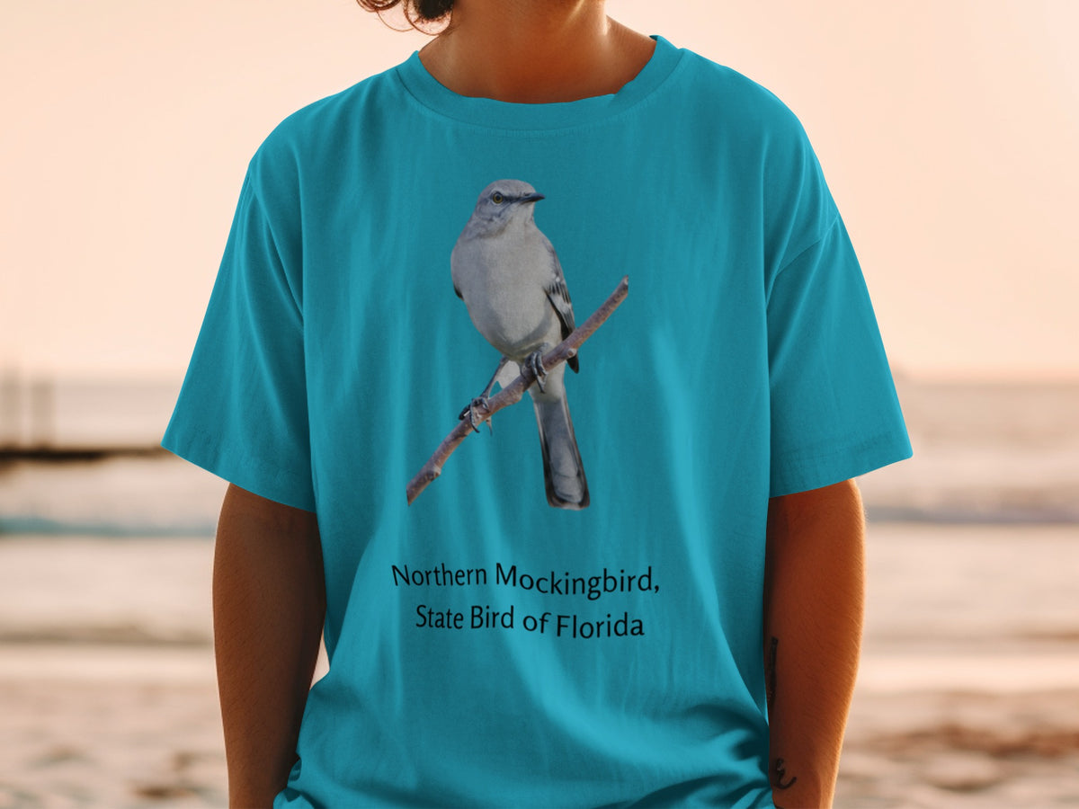 Teal t-shirt with northern mockingbird, state bird of Florida graphic.