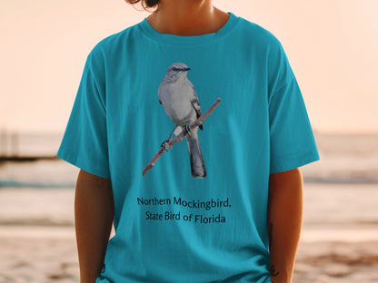 Teal t-shirt with northern mockingbird, state bird of Florida graphic.