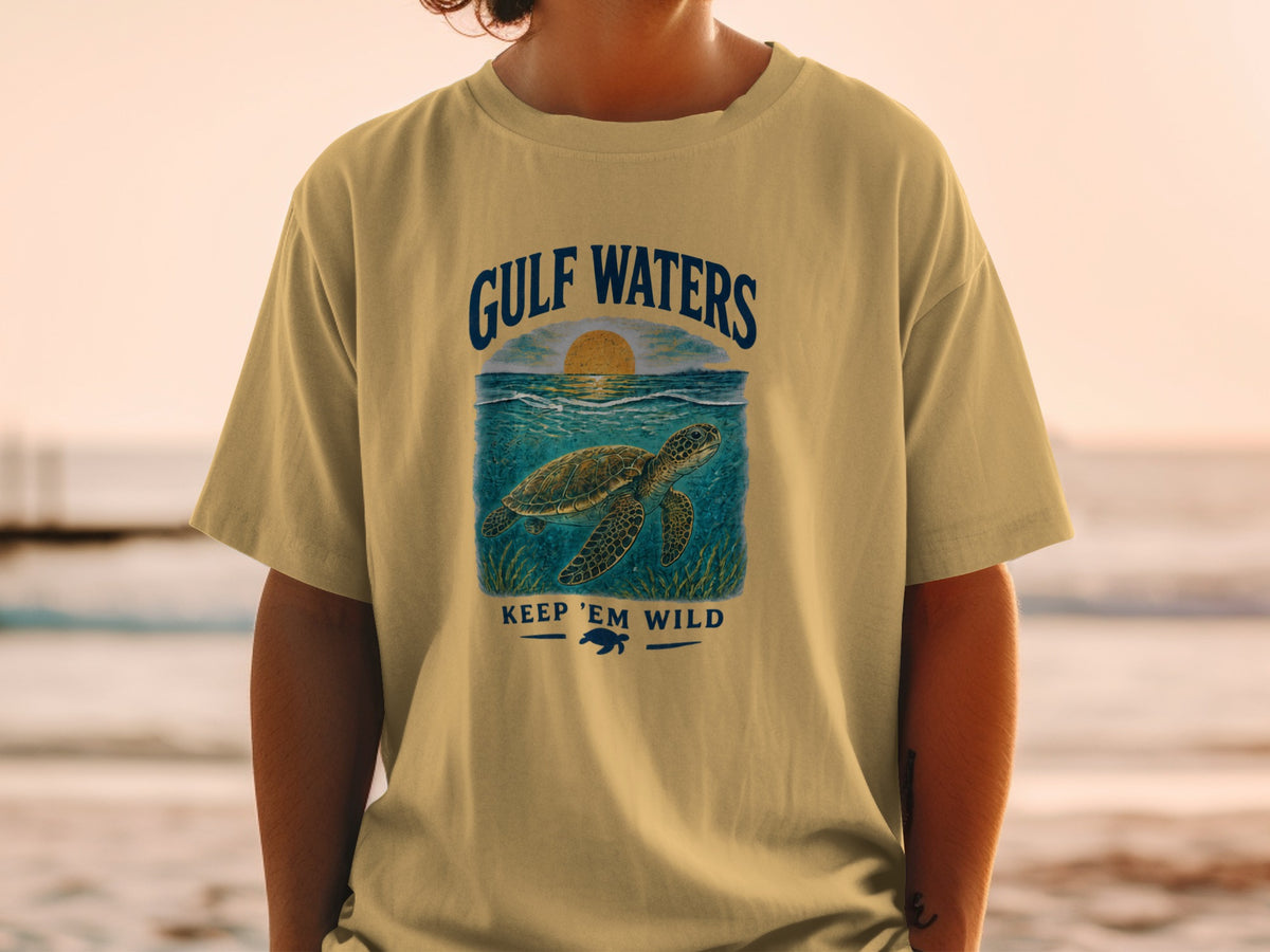 Yellow t-shirt with a sea turtle graphic and text "GULF WATERS KEEP 'EM WILD."