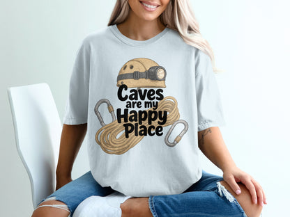 Light blue t-shirt with illustration of caving helmet, rope, and carabiners, text "Caves are my Happy Place".