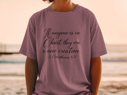 Mauve t-shirt with text "If anyone is in Christ, they are a new creation. -2 Corinthians 5:17"