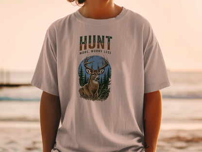 T-shirt graphic with buck, trees, and text "HUNT MORE, WORRY LESS".