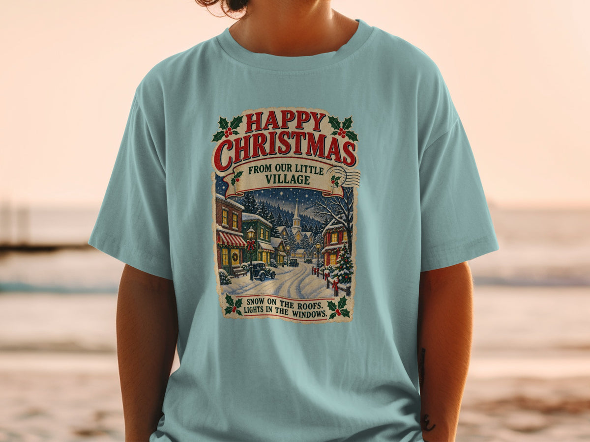 T-shirt with "Happy Christmas From Our Little Village" and a snowy village scene.