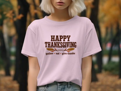 Pink t-shirt with "Happy Thanksgiving gather eat give thanks" text and wheat graphic.