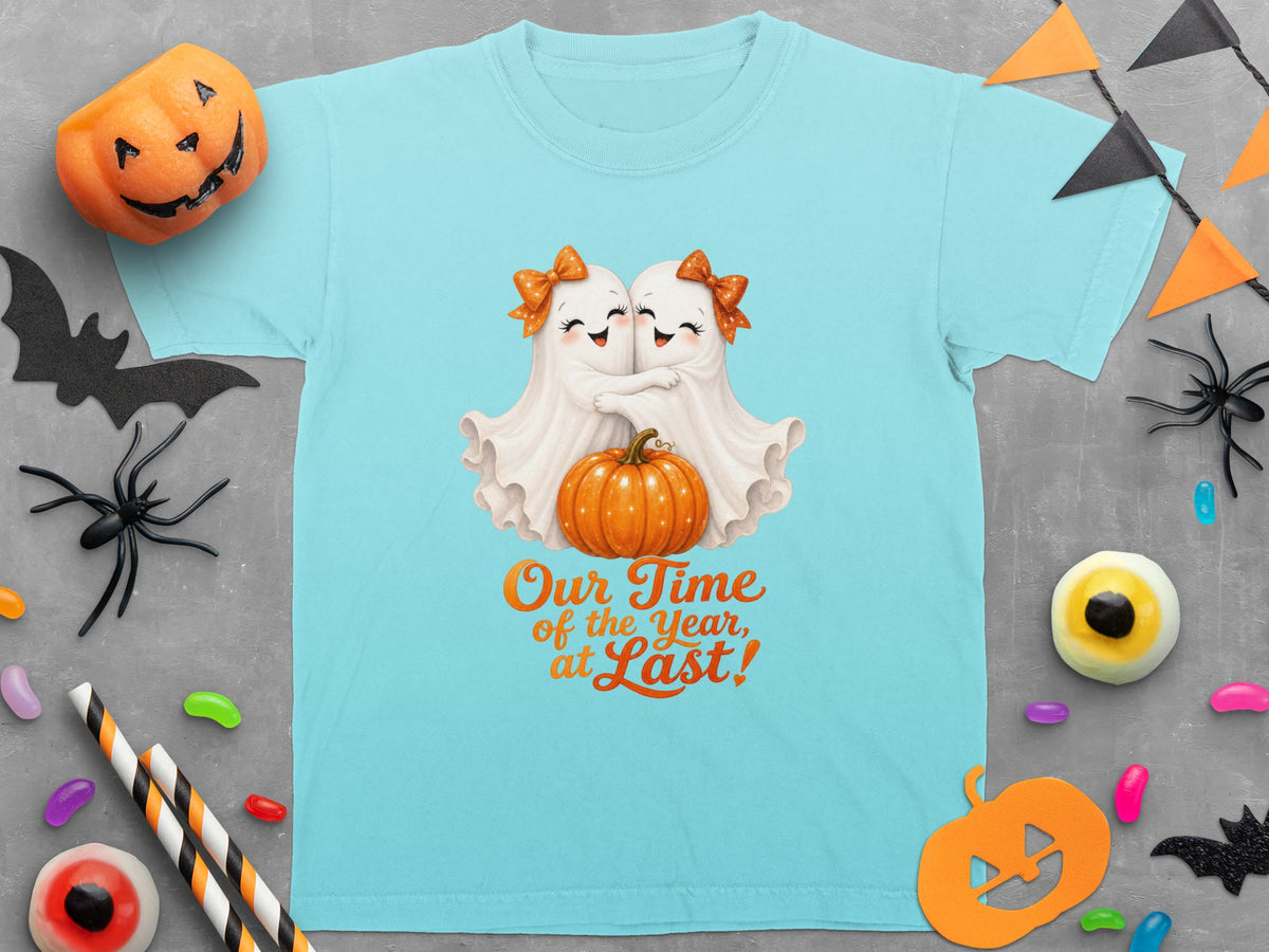 Two cute ghosts hug holding a pumpkin, with text "Our Time of the Year, at Last!"