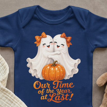 Two cute ghosts hug by a pumpkin, with text that reads "Our Time of the Year, at Last!"