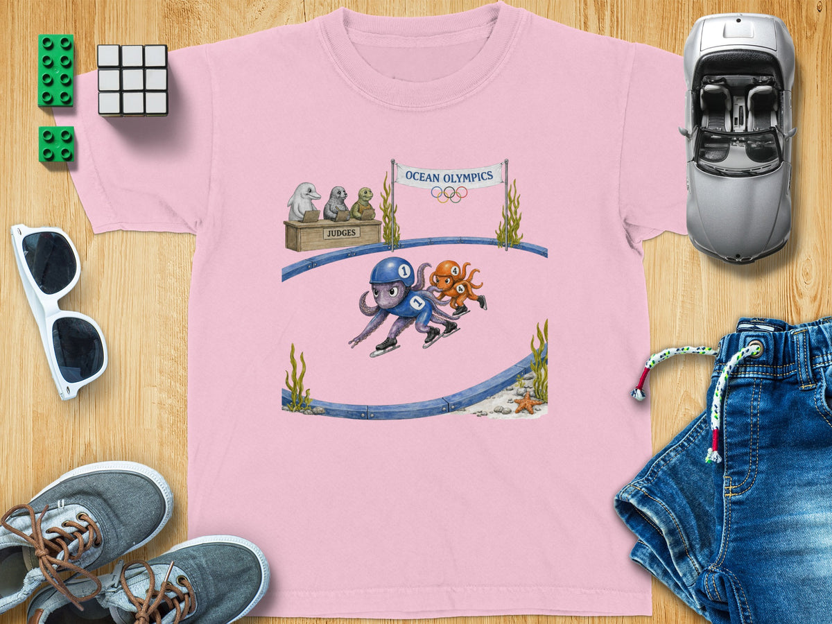 Pink t-shirt with "Ocean Olympics" graphic of octopuses figure skating and seals judging.