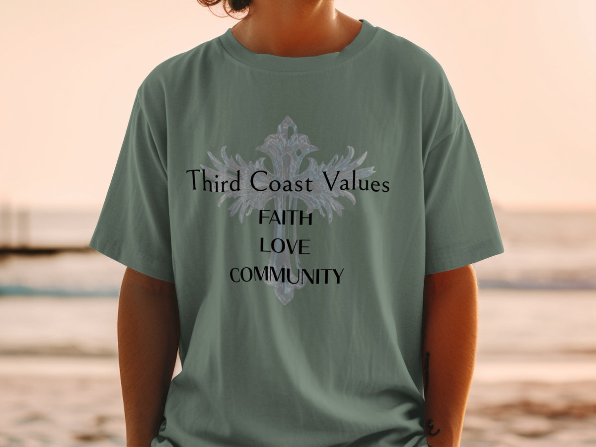 Green t-shirt with "Third Coast Values FAITH LOVE COMMUNITY" text and ornate cross design.