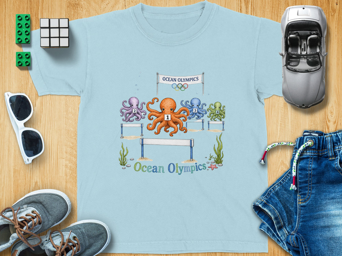 Light blue t-shirt with a cartoon of four numbered octopuses in a race under an "Ocean Olympics" banner.