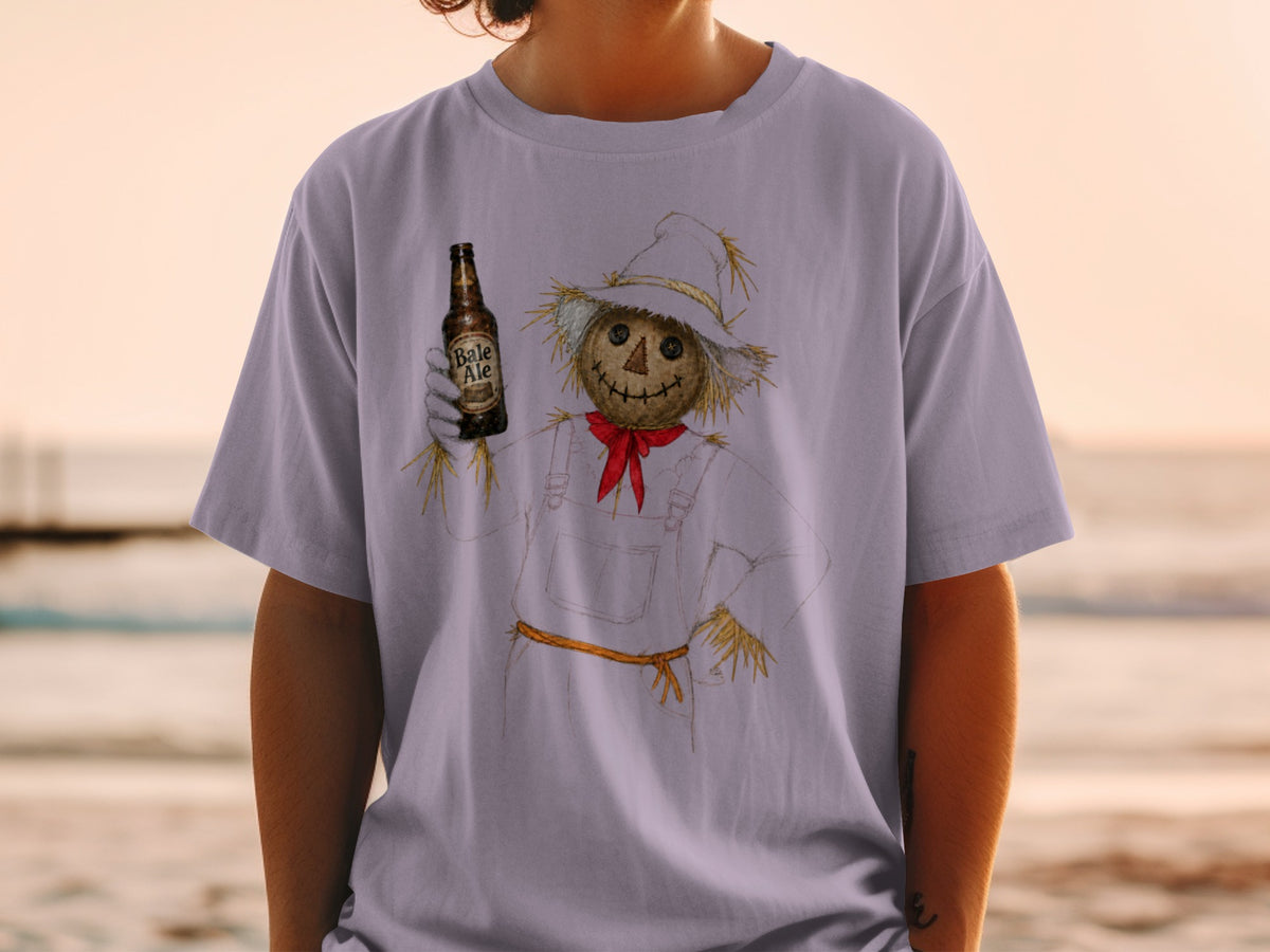 Scarecrow with bottle of Bale Ale on a light purple t-shirt.