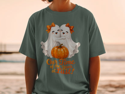 Two cute ghosts hug a pumpkin with text "Our Time of the Year, at Last!".