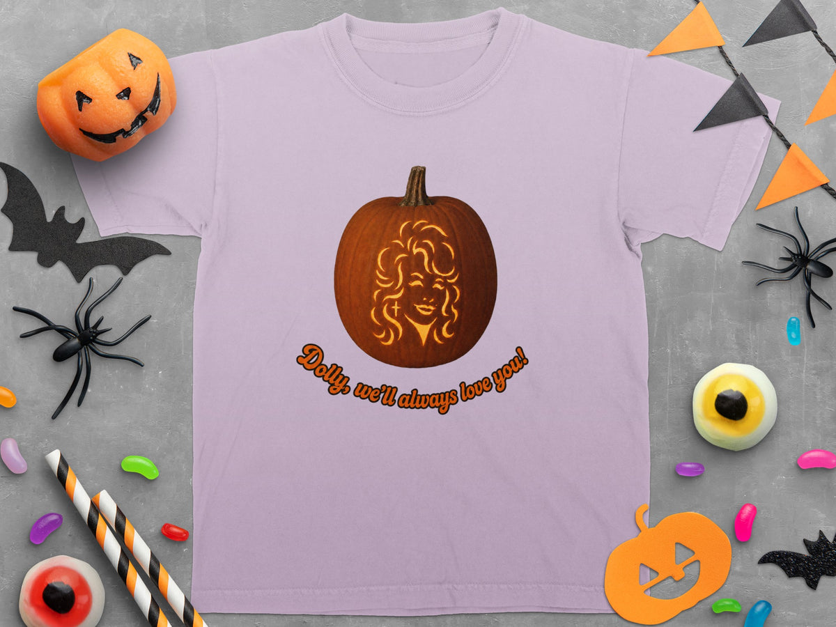 Lavender t-shirt with a carved pumpkin featuring a woman's face and text "Dolly, we'll always love you!".