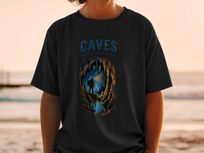 Black t-shirt with "CAVES" and cave explorer graphic.