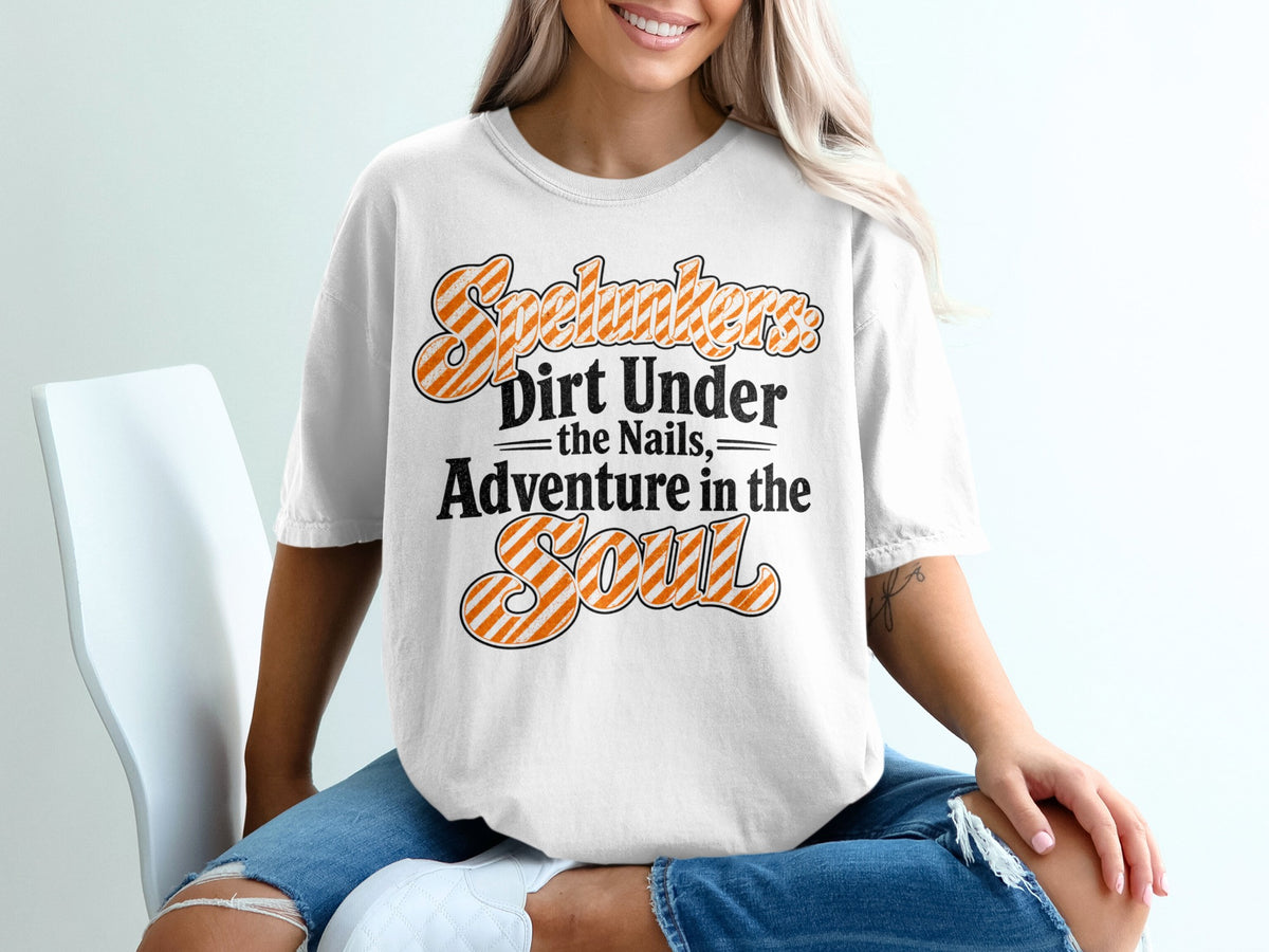 White t-shirt with "Spelunkers Dirt Under the Nails Adventure in the Soul" text.