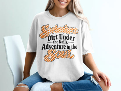 White t-shirt with "Spelunkers Dirt Under the Nails Adventure in the Soul" text.