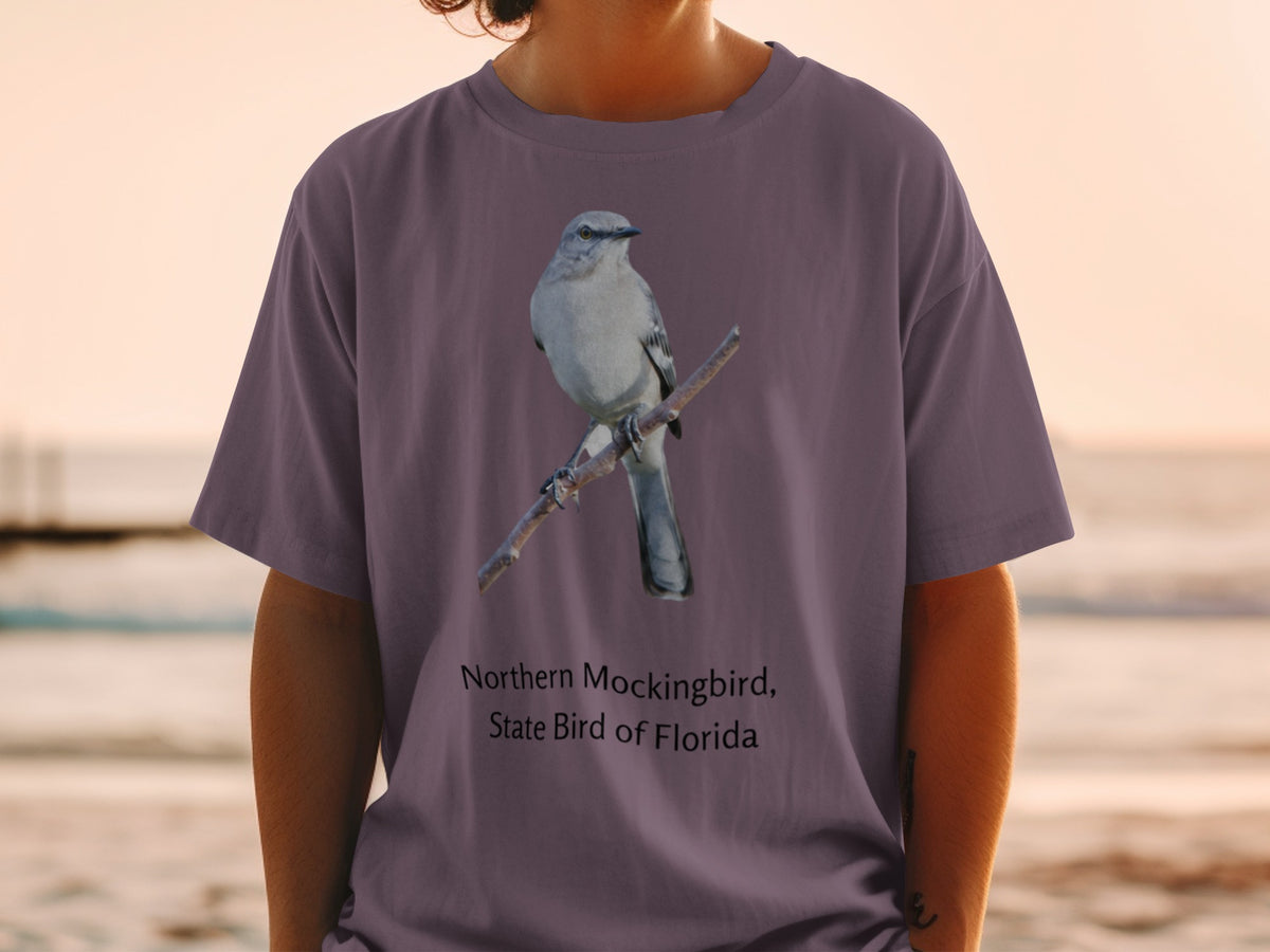 Northern Mockingbird, State Bird of Florida printed on a purple t-shirt.