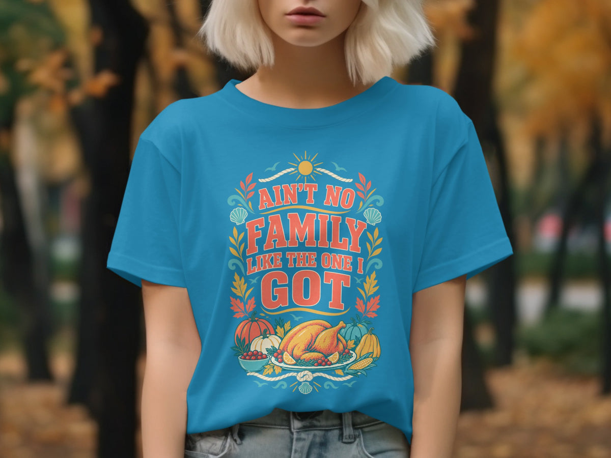 Blue t-shirt with "Ain't no family like the one I got" and Thanksgiving graphics.