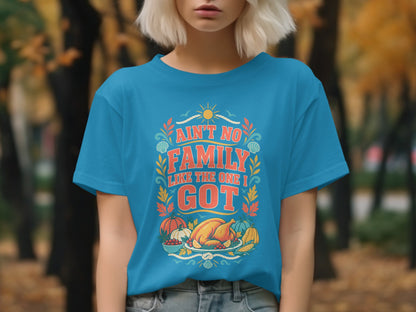 Blue t-shirt with "Ain't no family like the one I got" and Thanksgiving graphics.