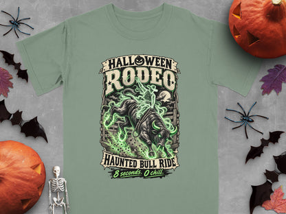 Green t-shirt with "Halloween Rodeo Haunted Bull Ride" graphic.